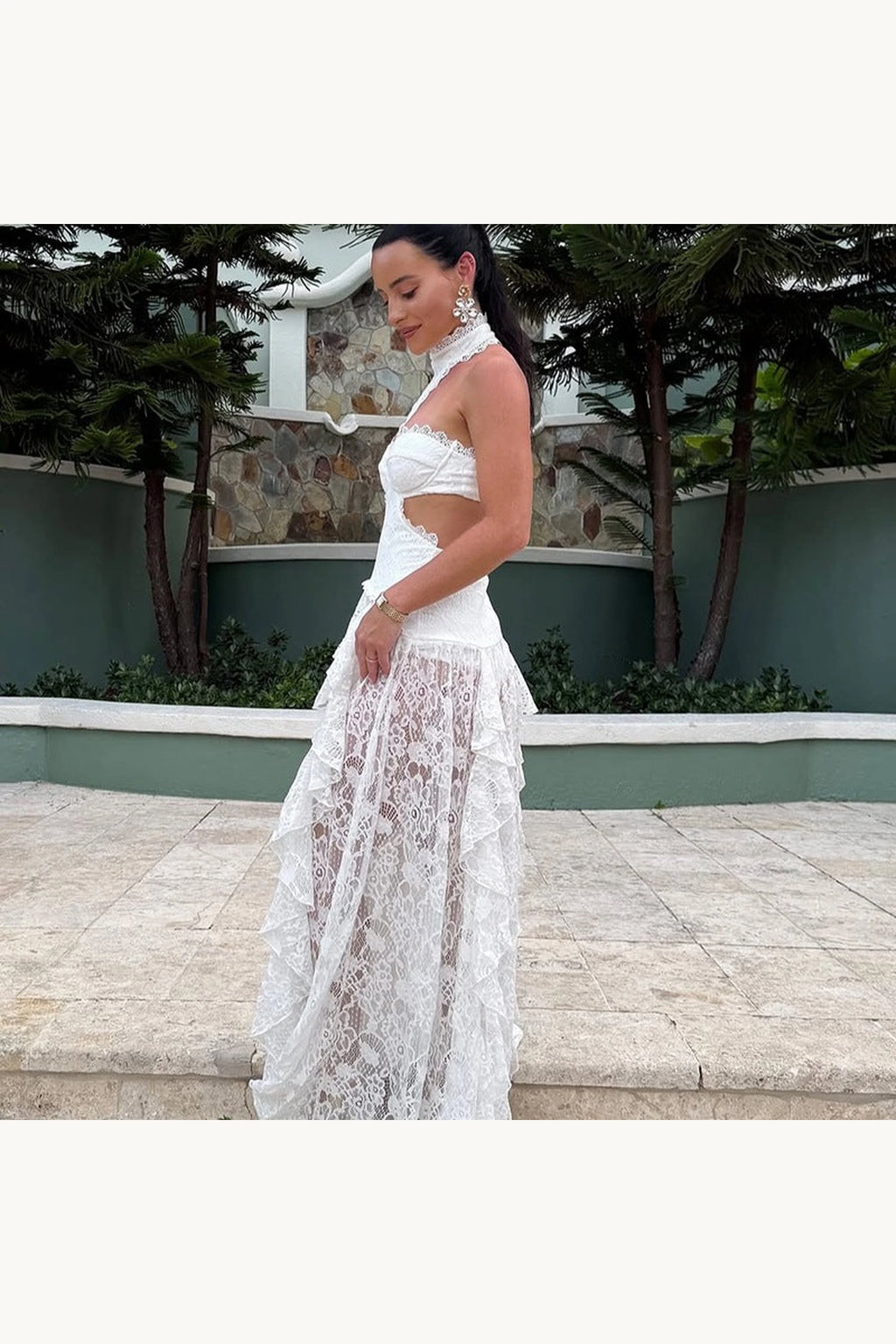 Robe bohème longue dentelle Sienna blanche vue de profil, découpes latérales, bustier structuré et jupe transparente en dentelle ajourée