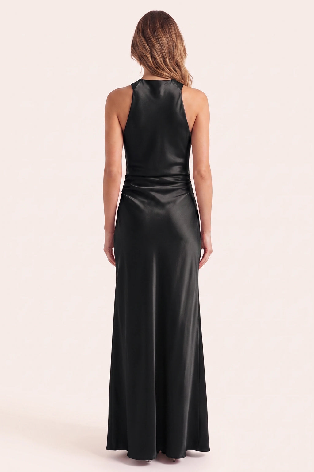 Robe de soirée satinée Élena noire portée de dos sur fond neutre clair, haut du dos conforme, col licou et silhouette longue élégante