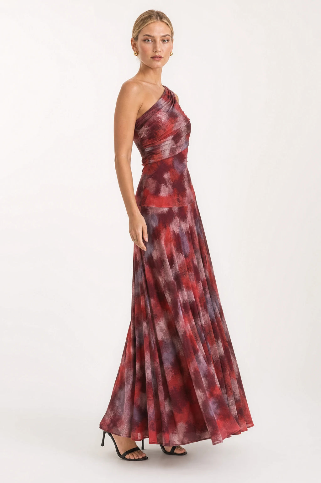 Robe vintage longue une épaule Isaline vue de profil portée par Sophie, jupe maxi fluide en mouvement avec imprimé marbré rouge bordeaux et gris fumé